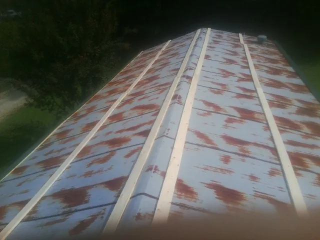 Rusted metal roof panels with new wood purlins before replacement — Storm Damage Roof Repair in Liverpool by Roofing Brothers