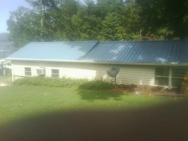 Blue metal roof running the length of a single story home in Liverpool